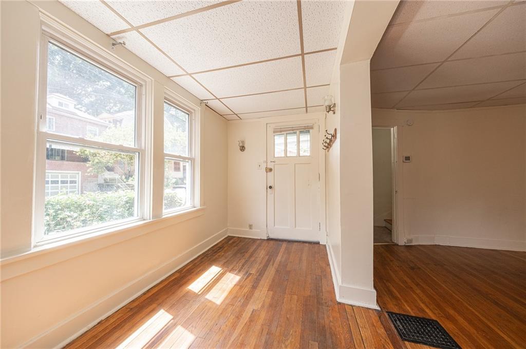 7315 Whipple Street Pittsburgh, PA 15218 - Photo 2 of 24 a view of a room with wooden floor and a window