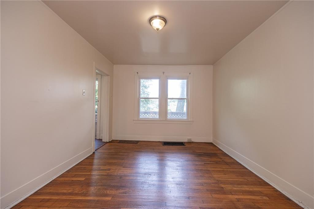 7315 Whipple Street Pittsburgh, PA 15218 - Photo 5 of 24 an empty room with wooden floor and windows