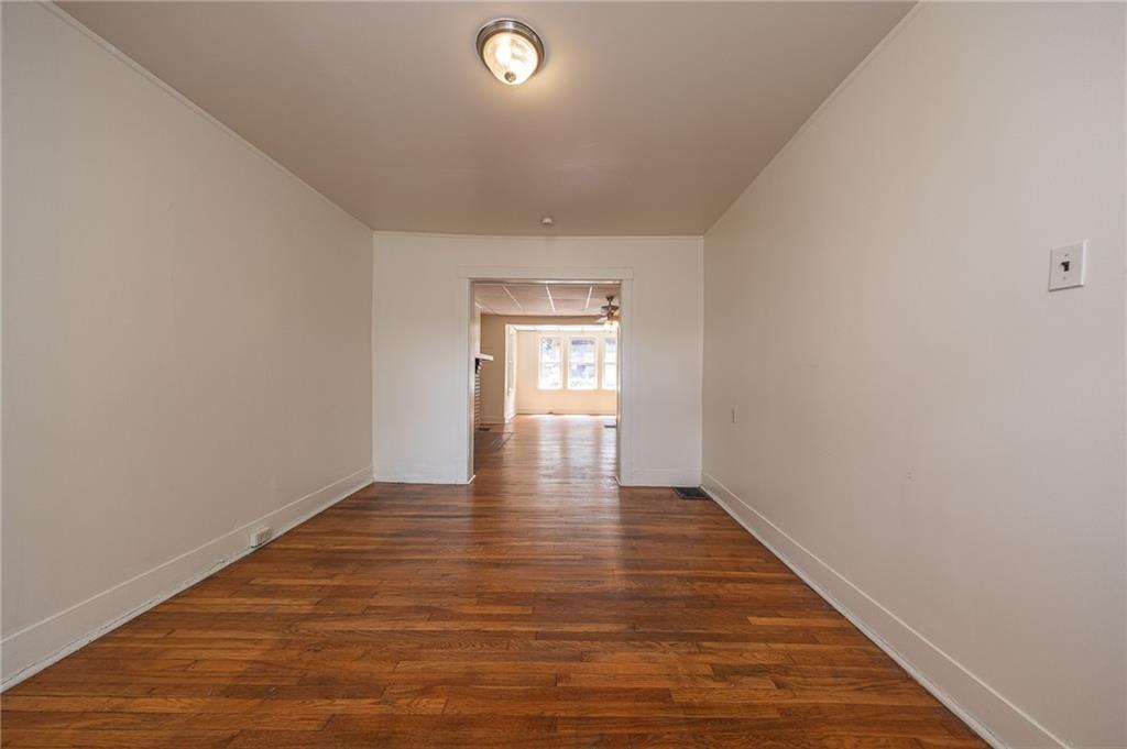 7315 Whipple Street Pittsburgh, PA 15218 - Photo 6 of 24 a view of an empty room with wooden floor and window