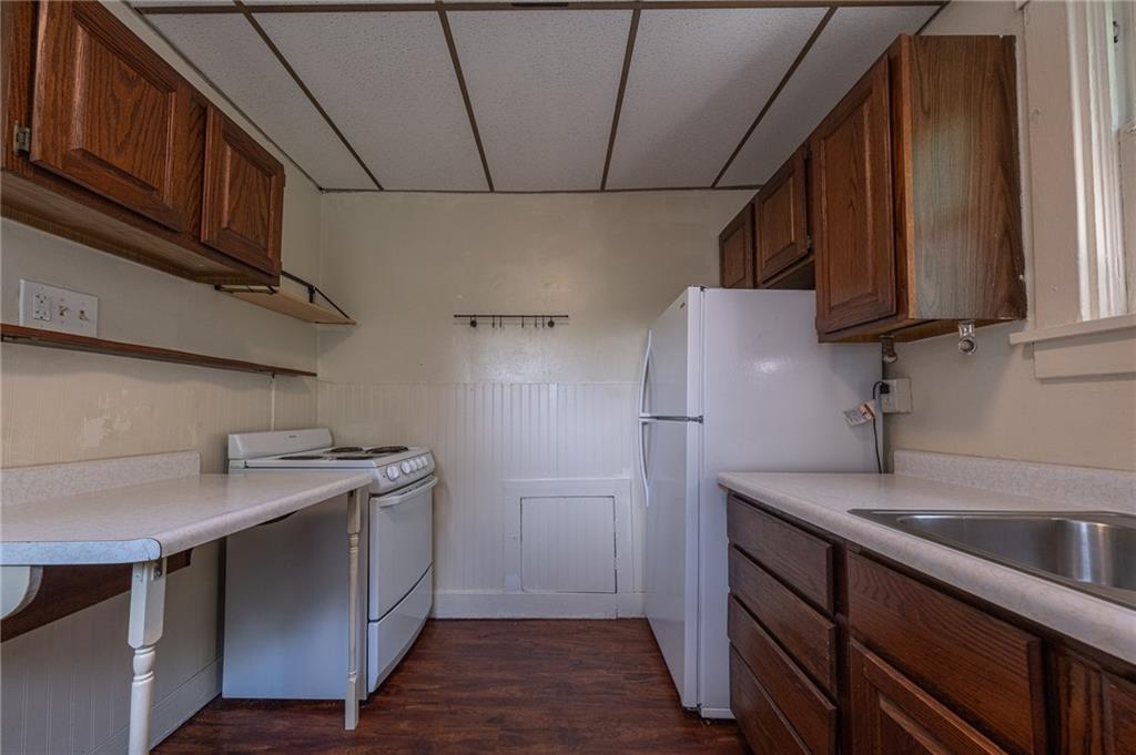 7315 Whipple Street Pittsburgh, PA 15218 - Photo 7 of 24 a kitchen with stainless steel appliances granite countertop a sink a stove and a refrigerator