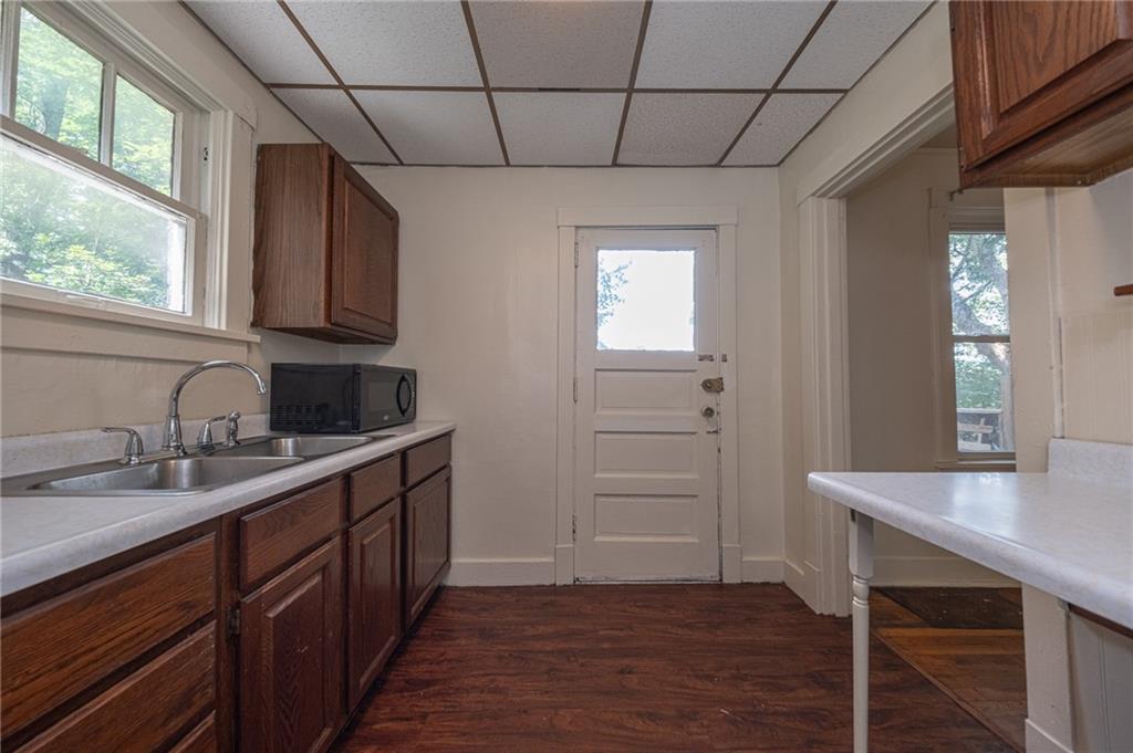 7315 Whipple Street Pittsburgh, PA 15218 - Photo 8 of 24 a kitchen with a sink cabinets and wooden floor