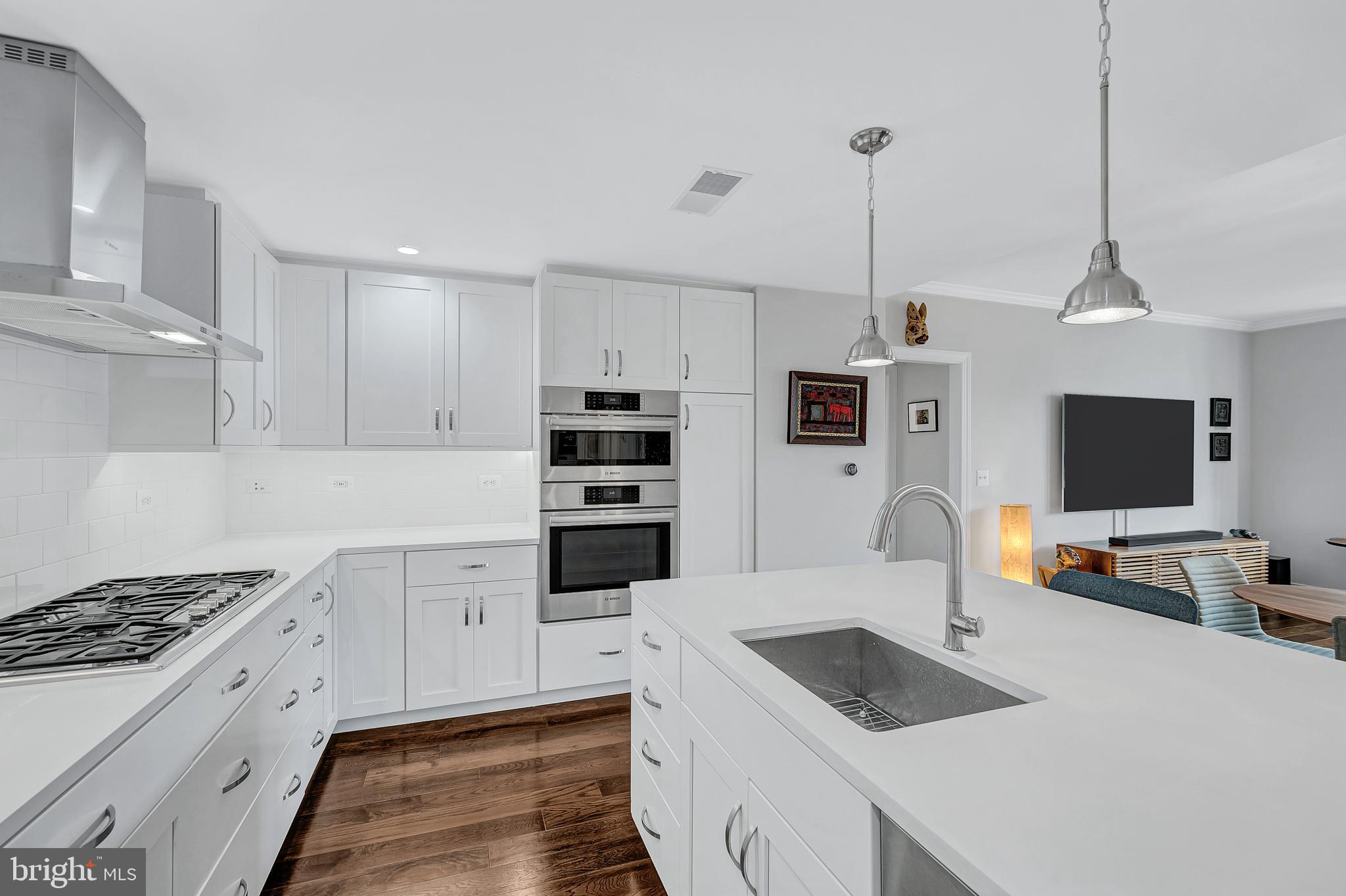 4915 Hampden Lane, Unit 204 Bethesda, MD 20814 - Photo 13 of 31 a kitchen with granite countertop a sink stove and refrigerator