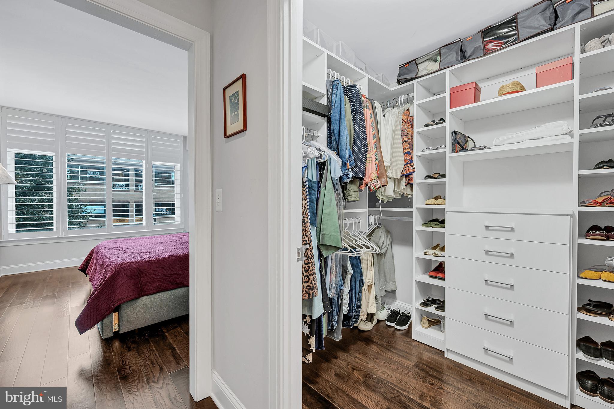4915 Hampden Lane, Unit 204 Bethesda, MD 20814 - Photo 17 of 31 a view of walk in closet with clothes and shoes