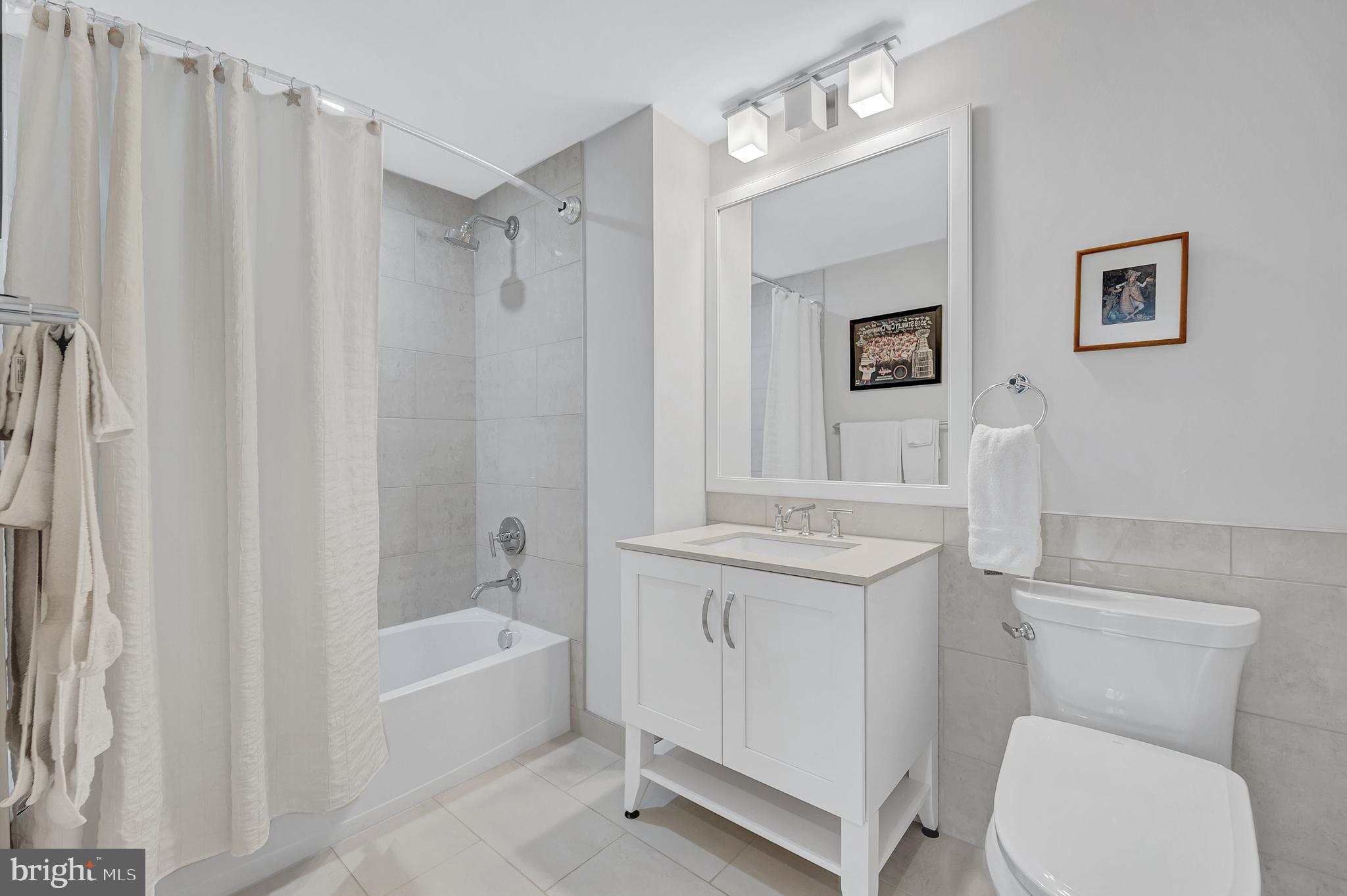 4915 Hampden Lane, Unit 204 Bethesda, MD 20814 - Photo 22 of 31 a bathroom with a toilet a sink and a bathtub