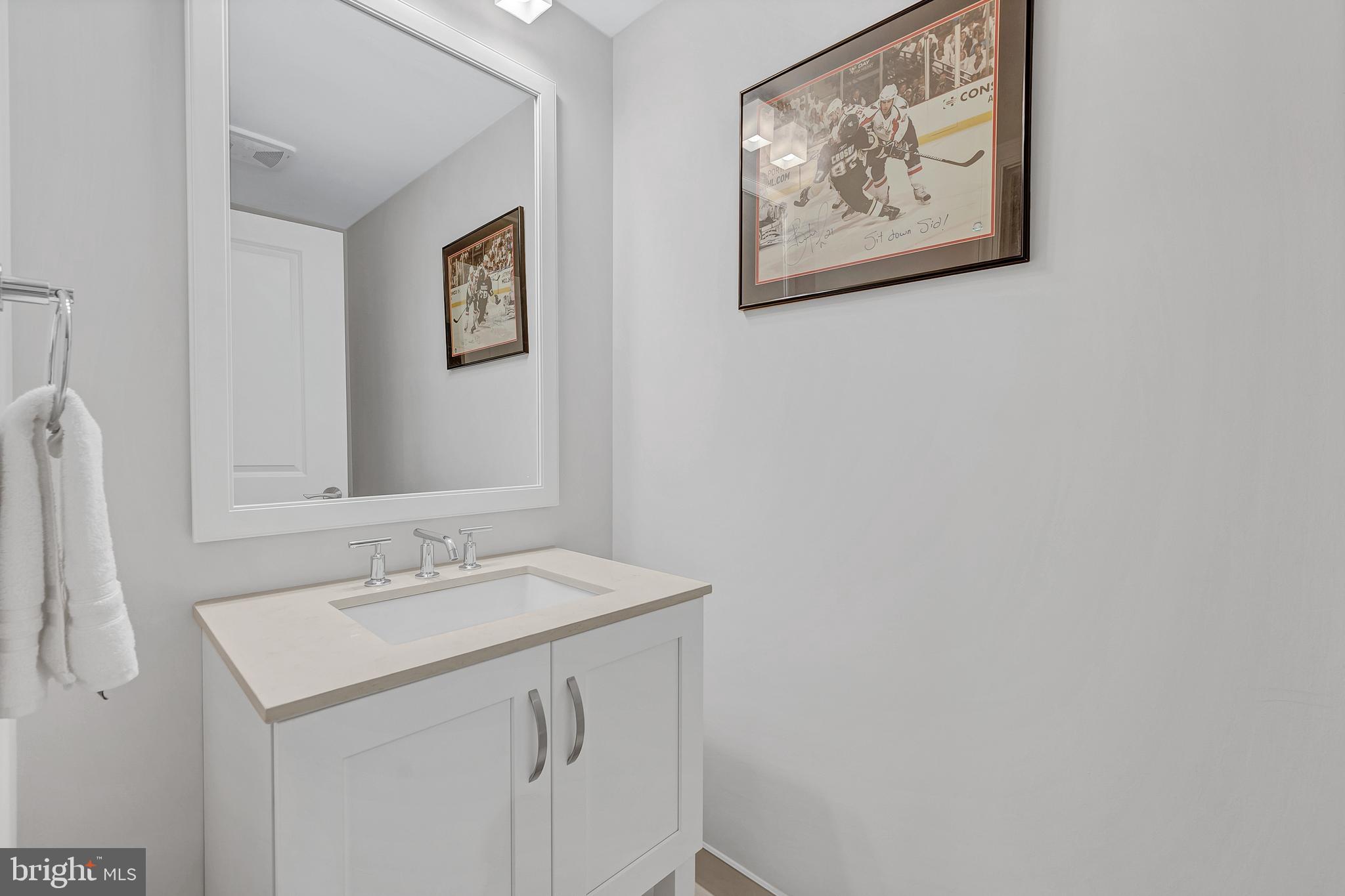 4915 Hampden Lane, Unit 204 Bethesda, MD 20814 - Photo 23 of 31 a bathroom with a sink and a mirror