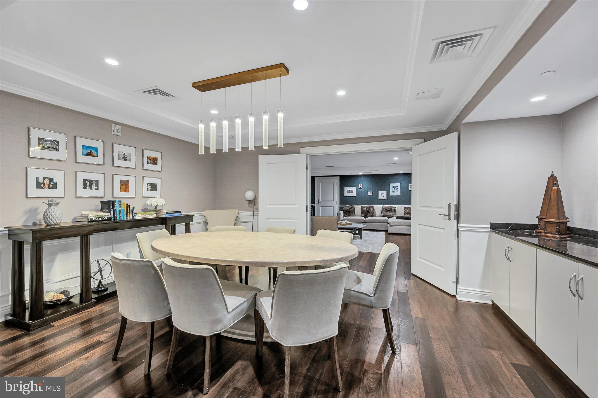 4915 Hampden Lane, Unit 204 Bethesda, MD 20814 - Photo 29 of 31 a view of a dining room with furniture and wooden floor
