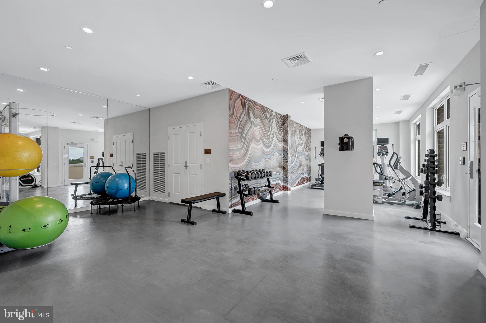 4915 Hampden Lane, Unit 204 Bethesda, MD 20814 - Photo 30 of 31 a living room with furniture and gym equipment