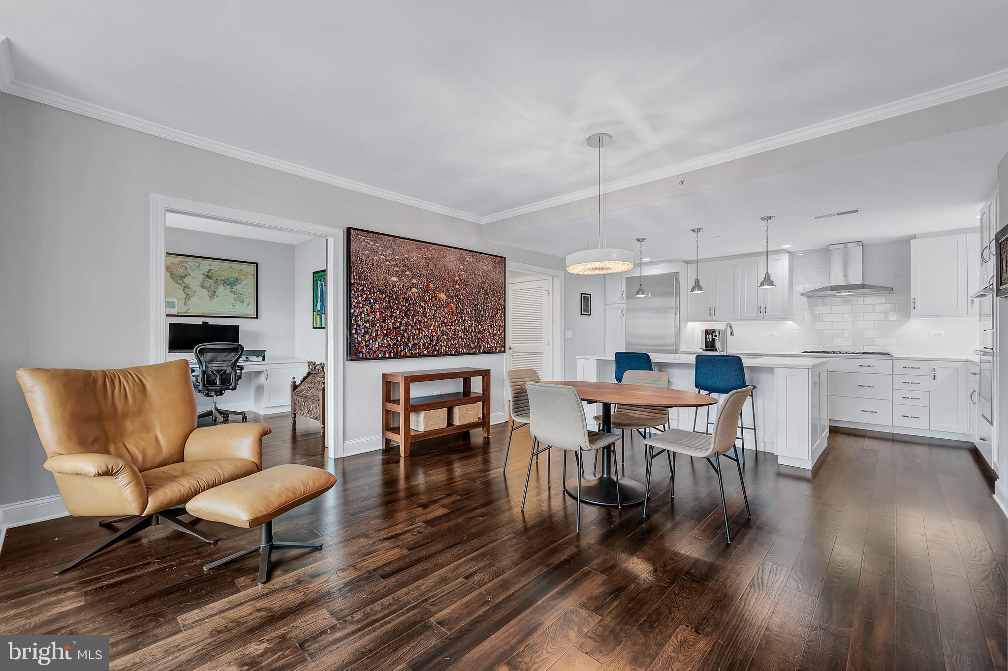 4915 Hampden Lane, Unit 204 Bethesda, MD 20814 - Photo 5 of 31 a living room with furniture a dining table wooden floor and a kitchen view