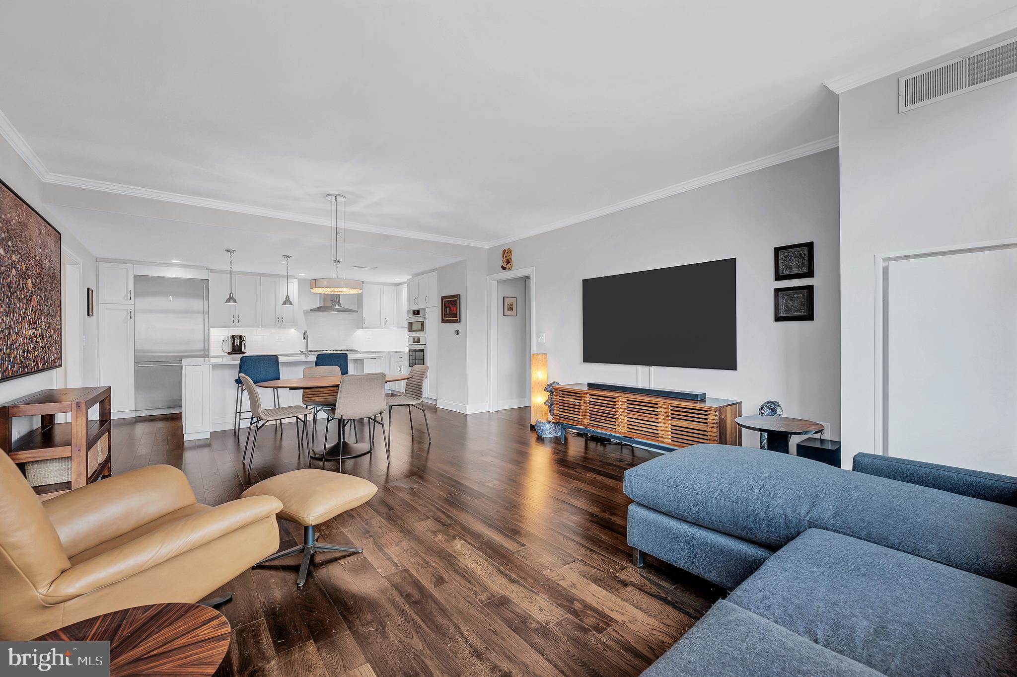 4915 Hampden Lane, Unit 204 Bethesda, MD 20814 - Photo 10 of 31 a living room with furniture and a flat screen tv