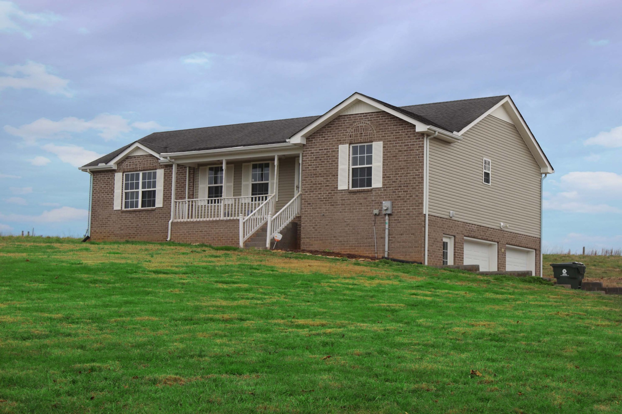 a front view of house with yard and green space
