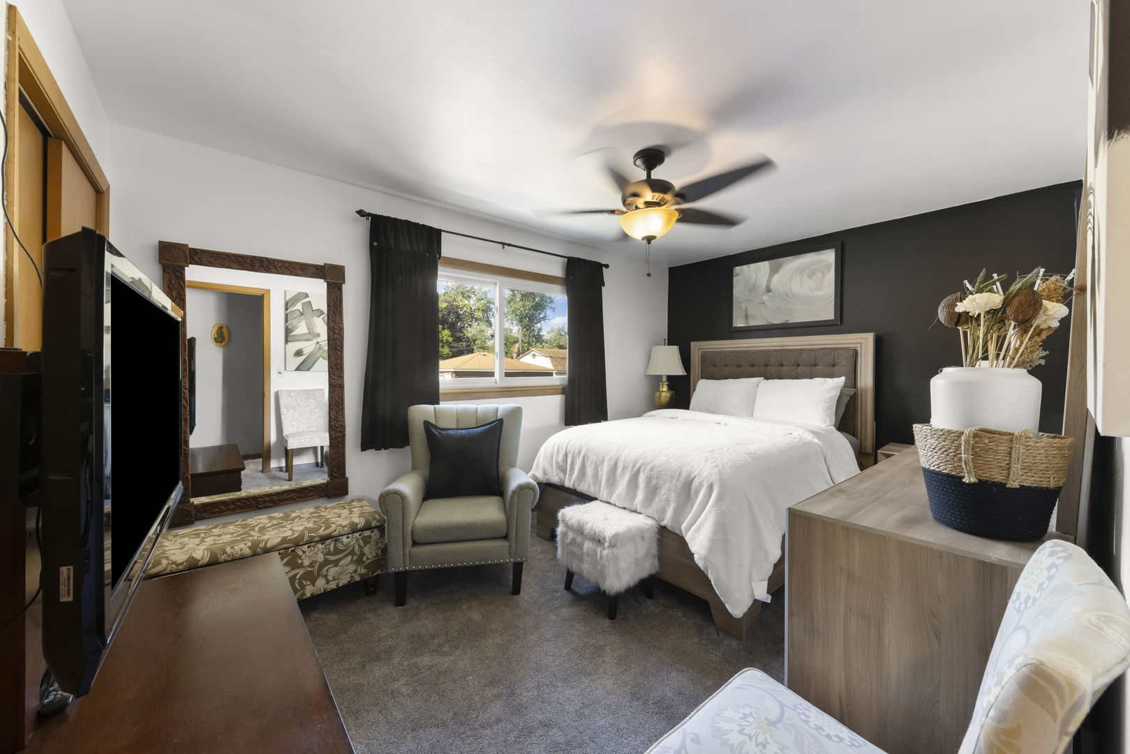 5628 Hawthorne Avenue Berkeley, IL 60163 - Photo 9 of 18 a spacious bedroom with a bed a couch and a chandelier