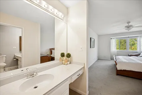a en suite bathroom with a double vanity sink and a mirror