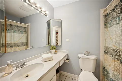 a bathroom with a sink vanity mirror and toilet
