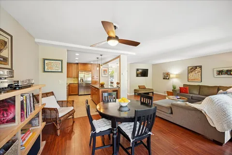 a living room with furniture a flat screen tv and a table