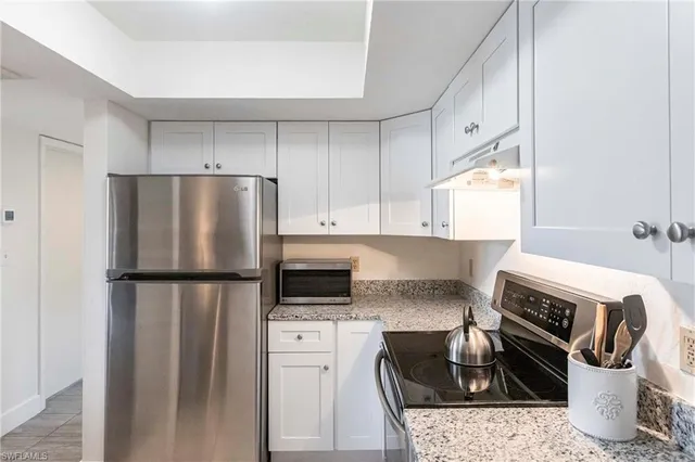 a kitchen with a refrigerator stove and sink