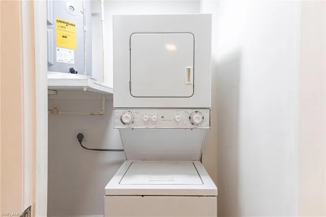 a view of a bedroom with furniture and balcony