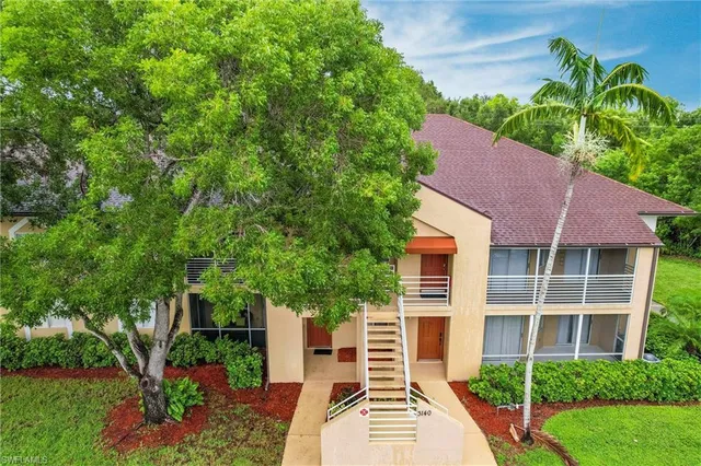 an aerial view of a house with yard swimming pool and outdoor seating