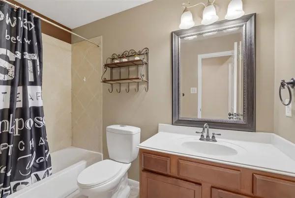 a bathroom with a sink vanity mirror and toilet