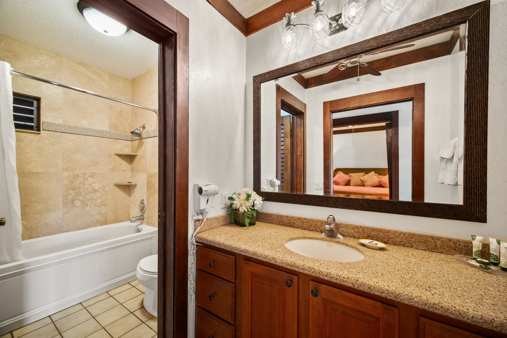 2253 Poipu Road, Unit 101 Koloa, HI 96756 - Photo 14 of 27 a bathroom with a granite countertop sink mirror and a bathtub