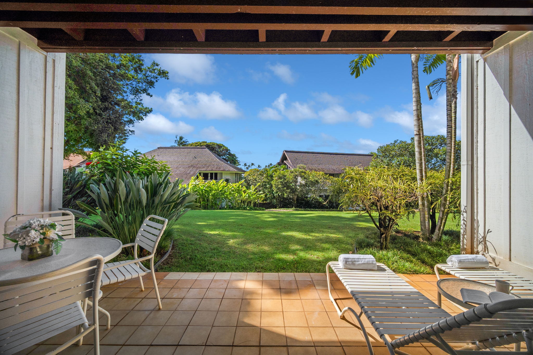 2253 Poipu Road, Unit 101 Koloa, HI 96756 - Photo 19 of 27 a view of a yard with a chair and a table