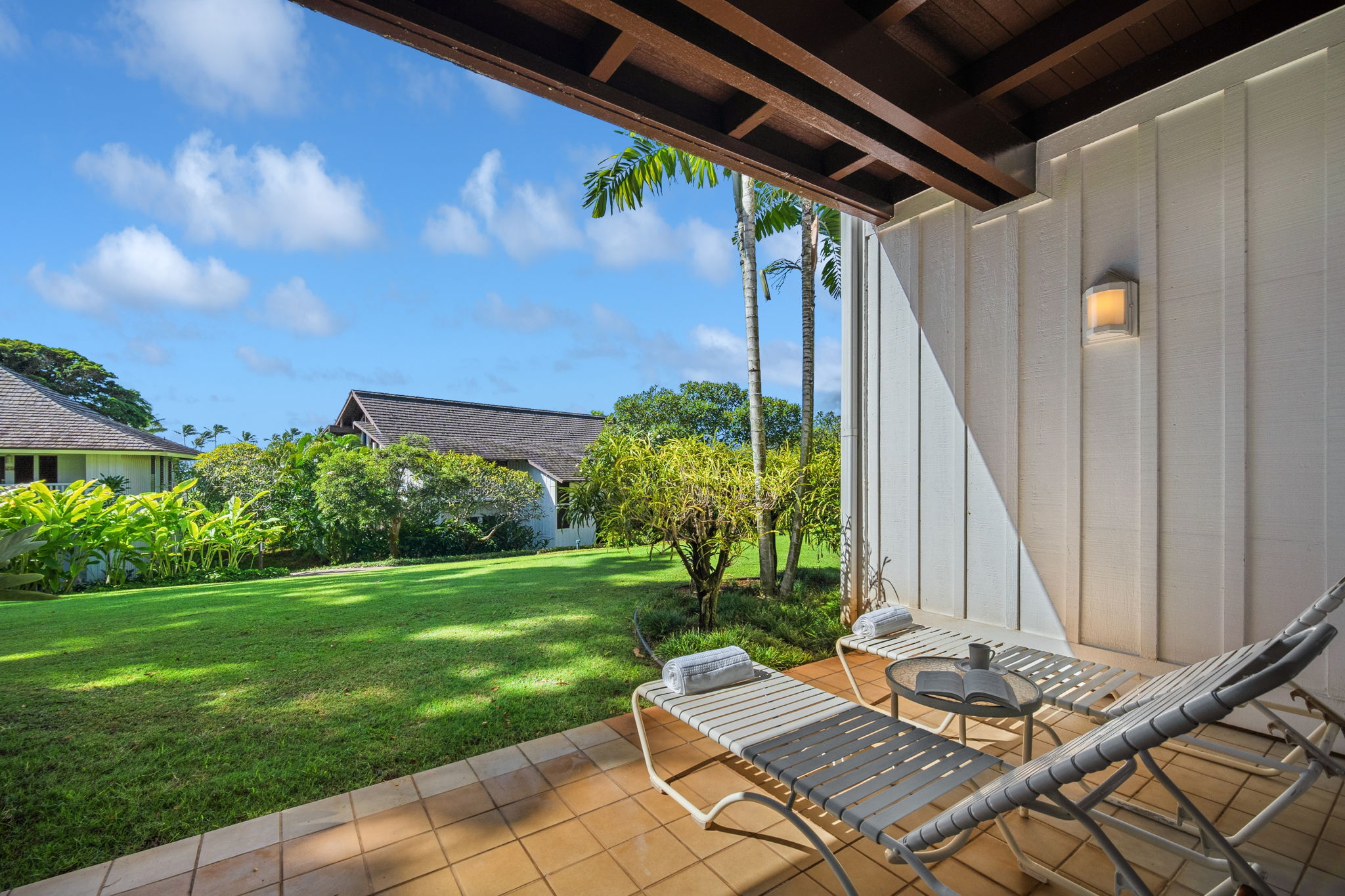 2253 Poipu Road, Unit 101 Koloa, HI 96756 - Photo 20 of 27 a backyard of a house with table and chairs