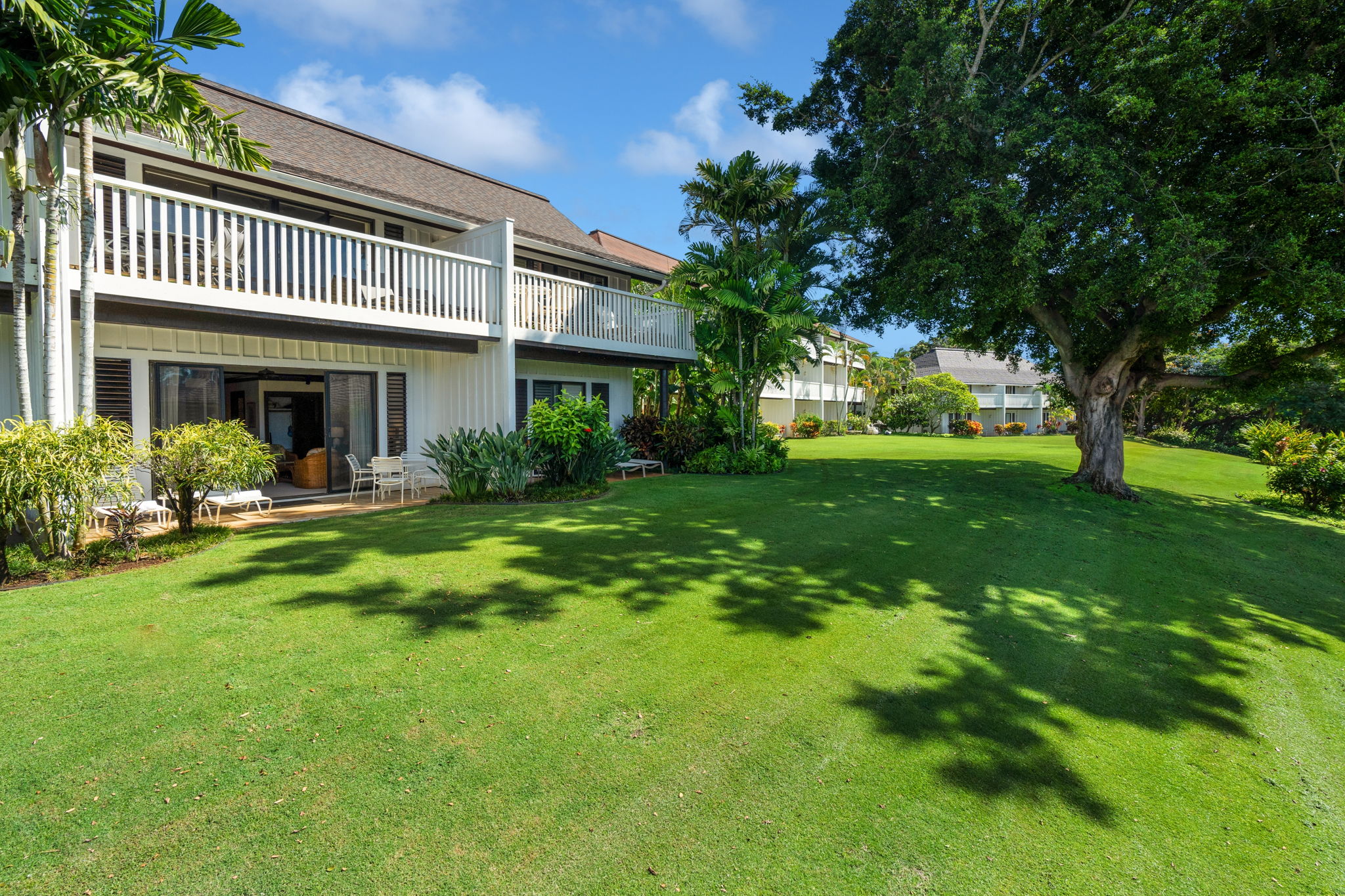 2253 Poipu Road, Unit 101 Koloa, HI 96756 - Photo 21 of 27 a view of a house with a garden