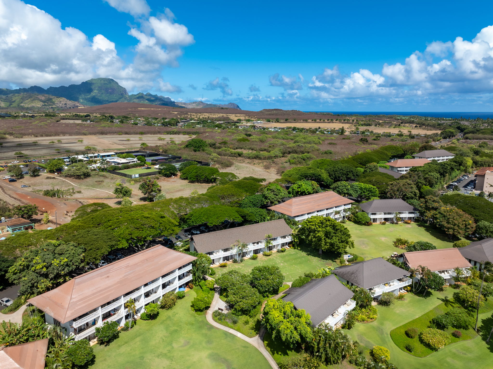 2253 Poipu Road, Unit 101 Koloa, HI 96756 - Photo 26 of 27 a view of a city with mountains in the background