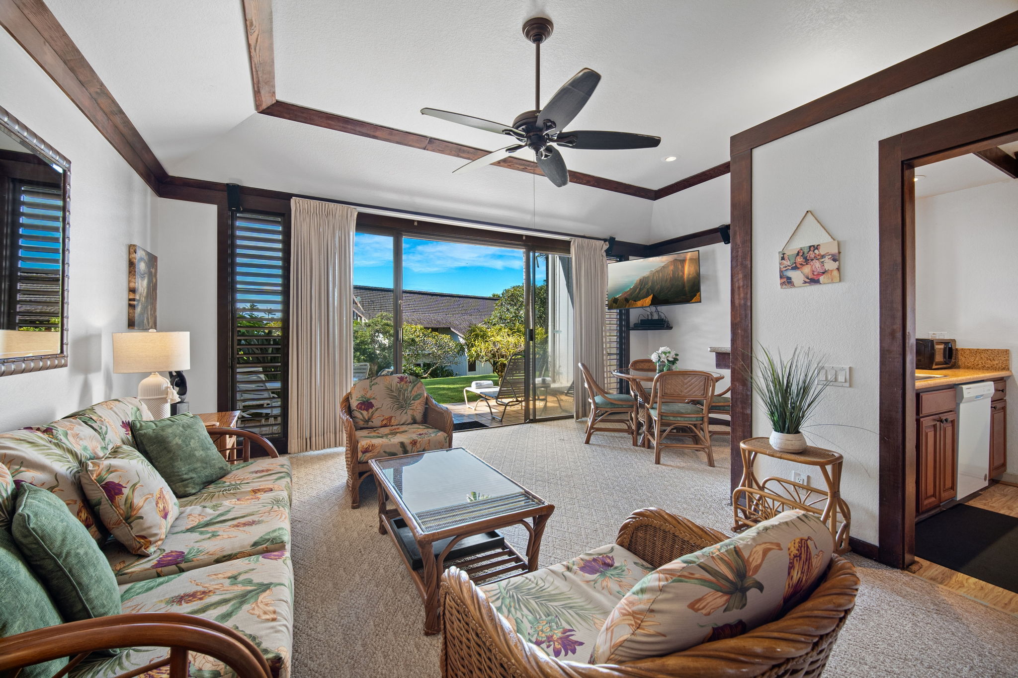 2253 Poipu Road, Unit 101 Koloa, HI 96756 - Photo 4 of 27 a living room with furniture ceiling fan and a large window