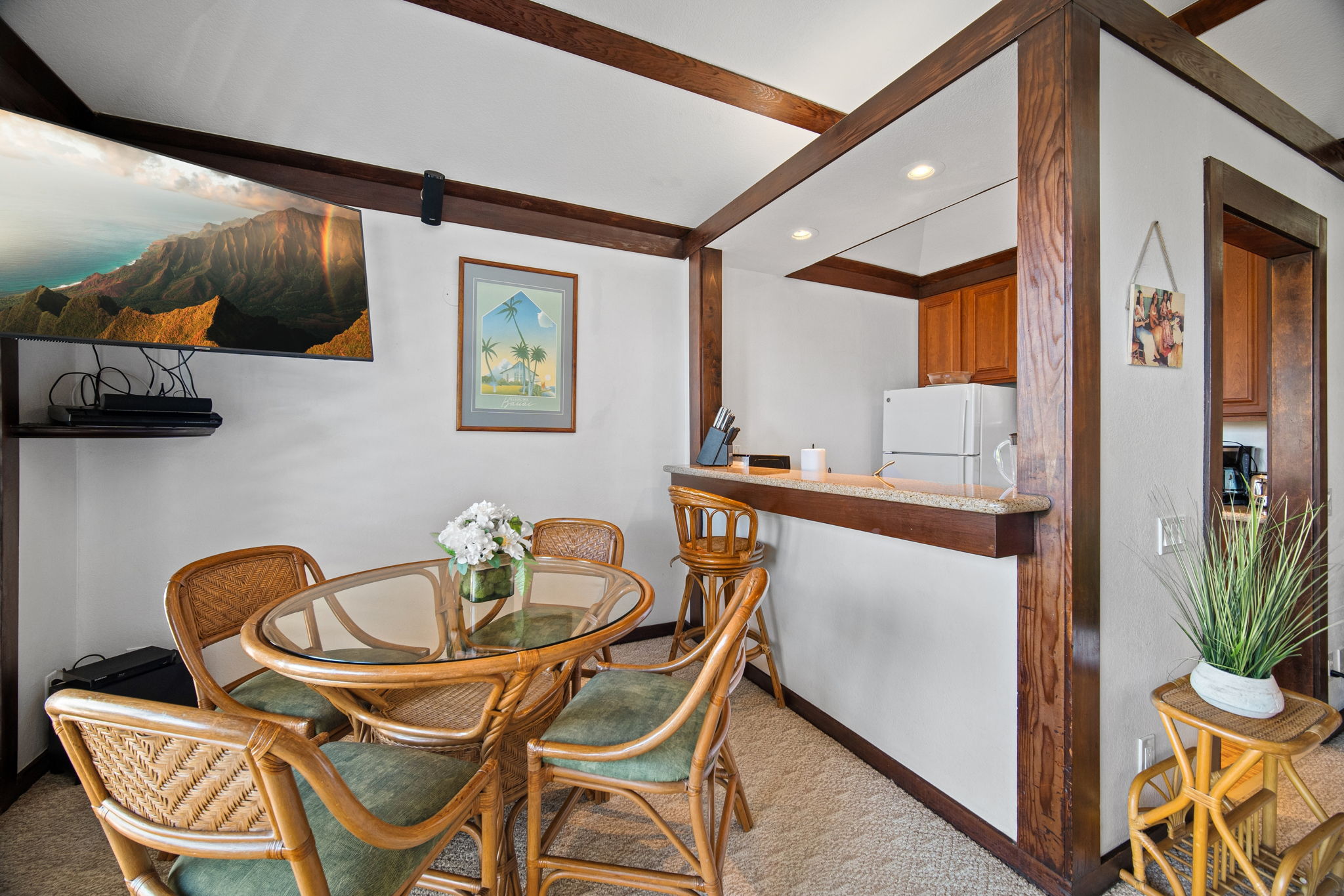 2253 Poipu Road, Unit 101 Koloa, HI 96756 - Photo 5 of 27 a dining room with furniture and wooden floor