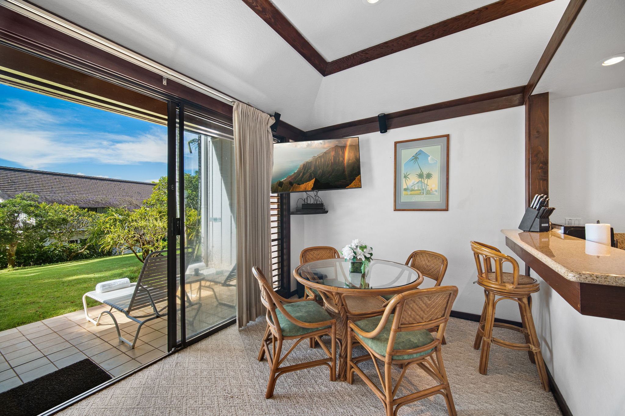 2253 Poipu Road, Unit 101 Koloa, HI 96756 - Photo 6 of 27 a dining room with furniture and a floor to ceiling window