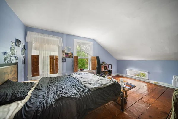 a bedroom with a large bed and a dresser