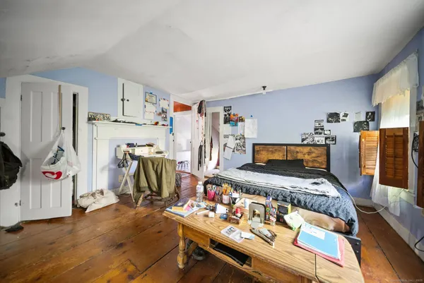 a bedroom with furniture and a flat screen tv