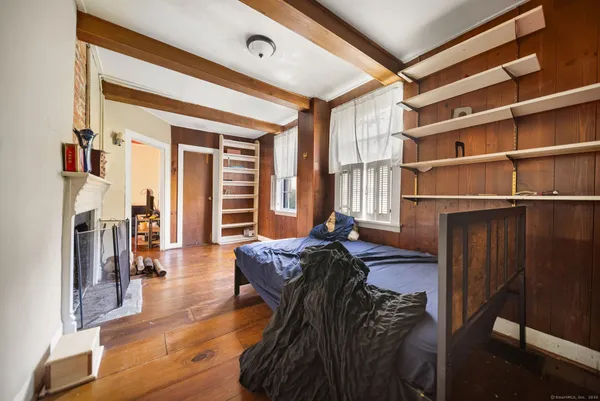 a living room with furniture fireplace and wooden floor