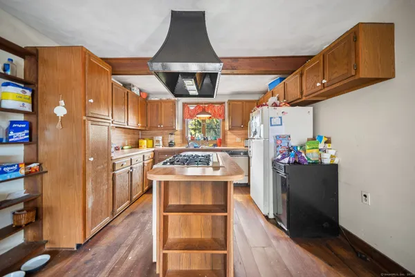 a kitchen with stainless steel appliances a stove a refrigerator and cabinets
