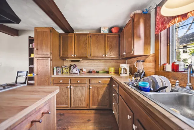 a kitchen with stainless steel appliances granite countertop a sink a stove and a refrigerator