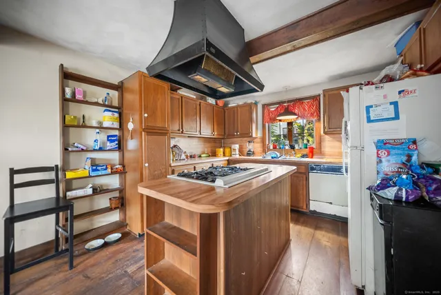 a kitchen with stainless steel appliances granite countertop a stove and a refrigerator
