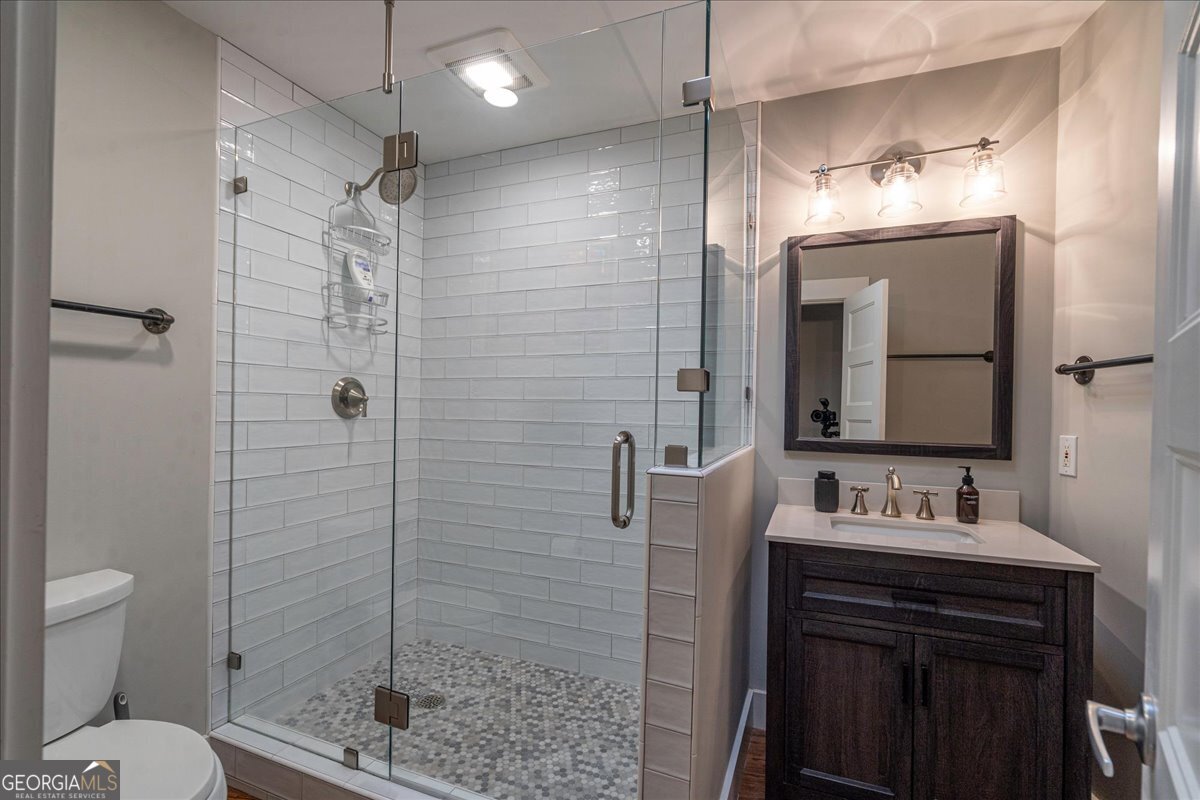 585 White Circle, Unit 402 Athens, GA 30605 - Photo 25 of 44 a bathroom with a sink toilet a mirror and shower