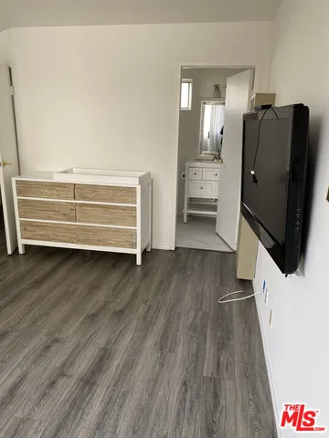 a view of a hardwood floor and wardrobe