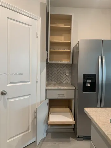 a bathroom with a refrigerator and a sink