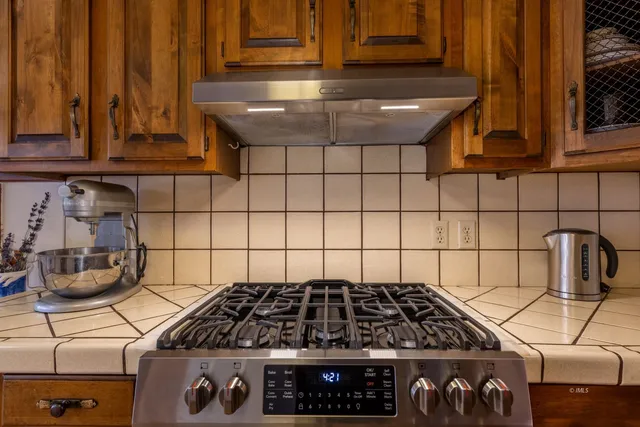 a kitchen with a stove and cabinets