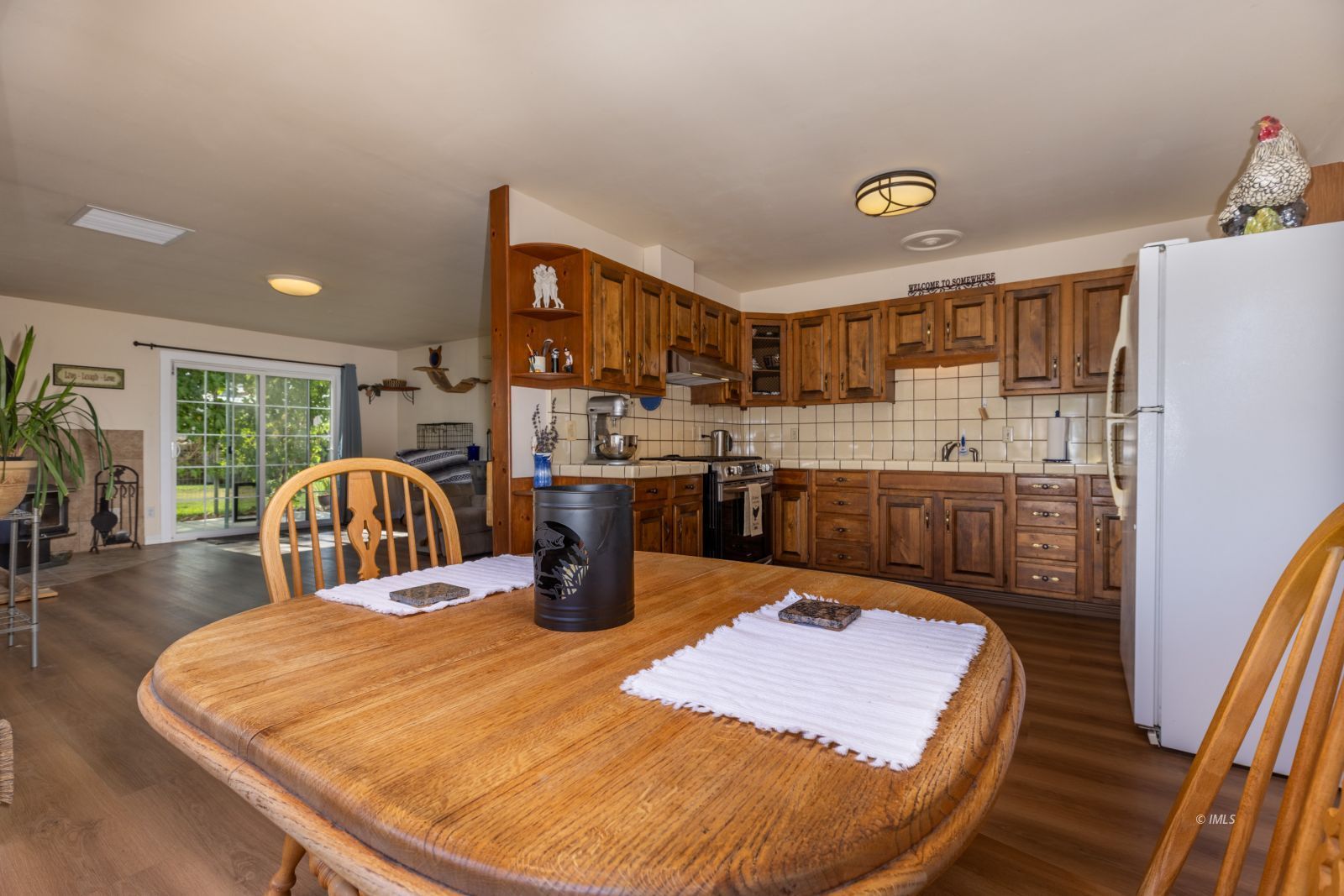 95 Mountain View Avenue Bishop, CA 93514 - Photo 14 of 35 a kitchen with sink refrigerator dining table and chairs