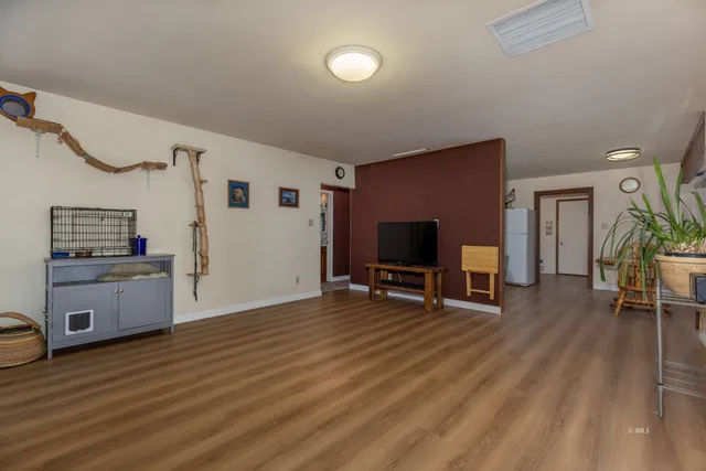 a view of a livingroom with furniture and a flat screen tv