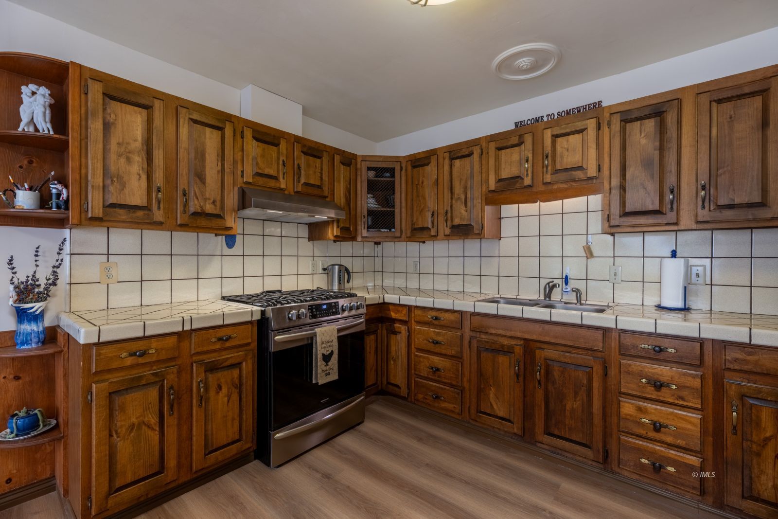 95 Mountain View Avenue Bishop, CA 93514 - Photo 10 of 35 a kitchen with stainless steel appliances wooden cabinets and a stove top oven
