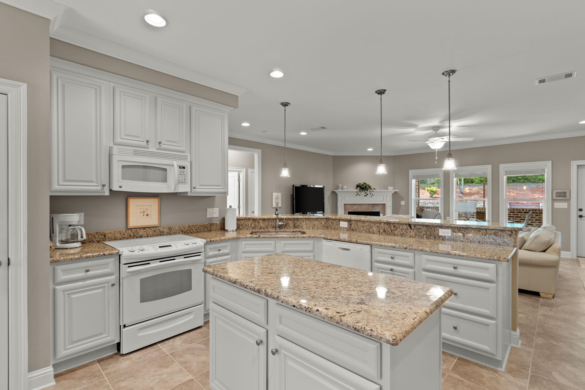 562 Falcon Trail Niceville, FL 32578 - Photo 12 of 40 a large kitchen with granite countertop a white stove top oven and cabinets