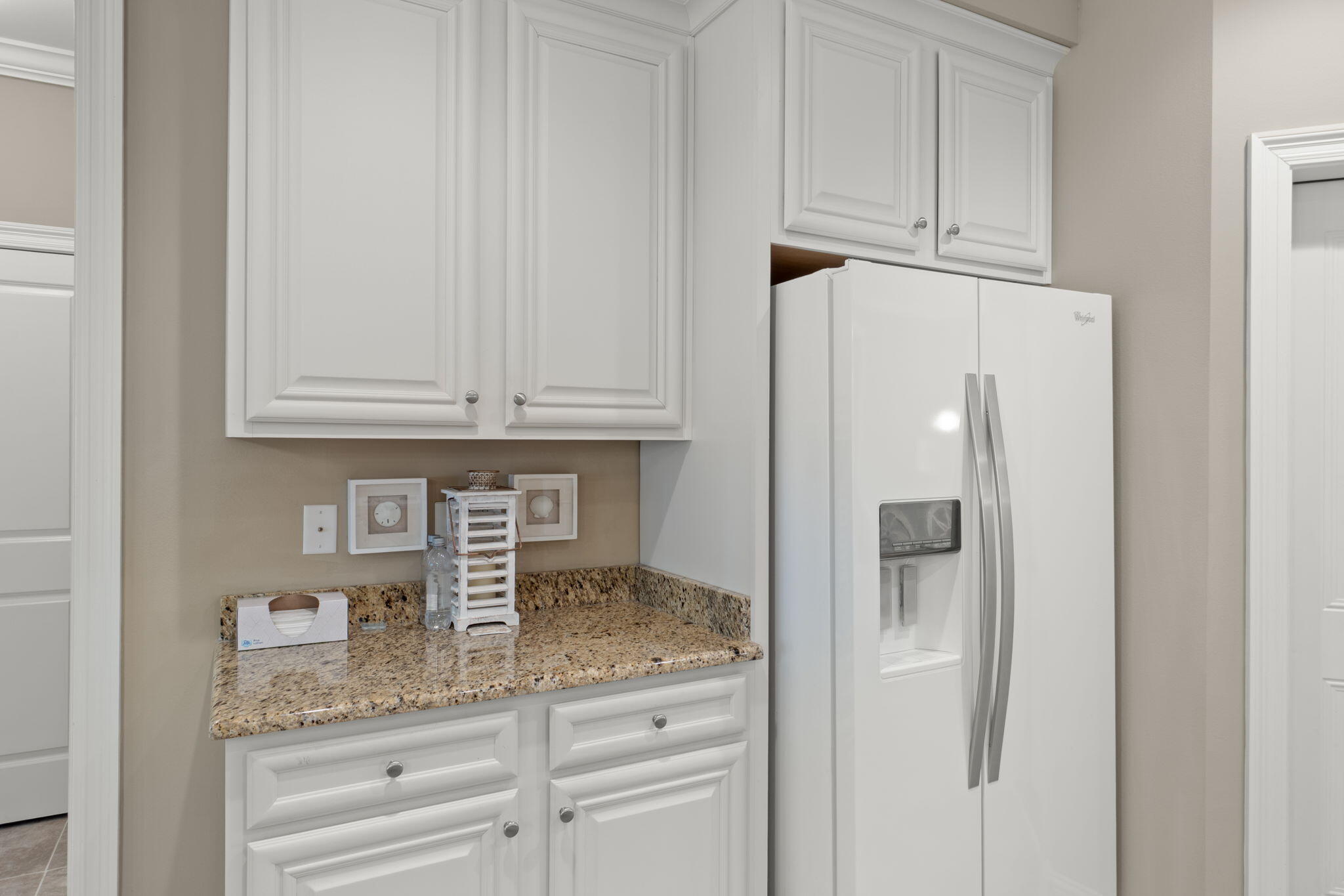 562 Falcon Trail Niceville, FL 32578 - Photo 14 of 40 a kitchen with granite countertop white cabinets and refrigerator