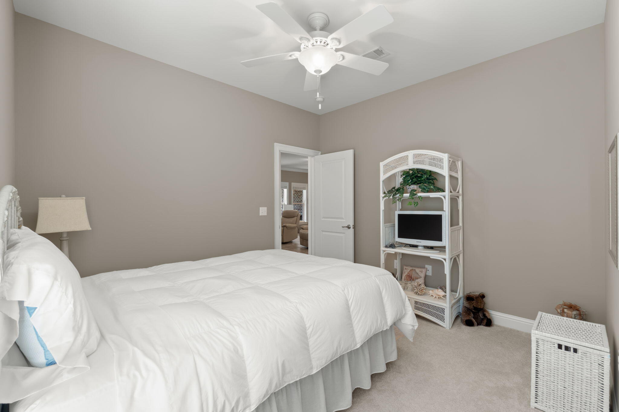 562 Falcon Trail Niceville, FL 32578 - Photo 19 of 40 a bedroom with a bed and a chandelier
