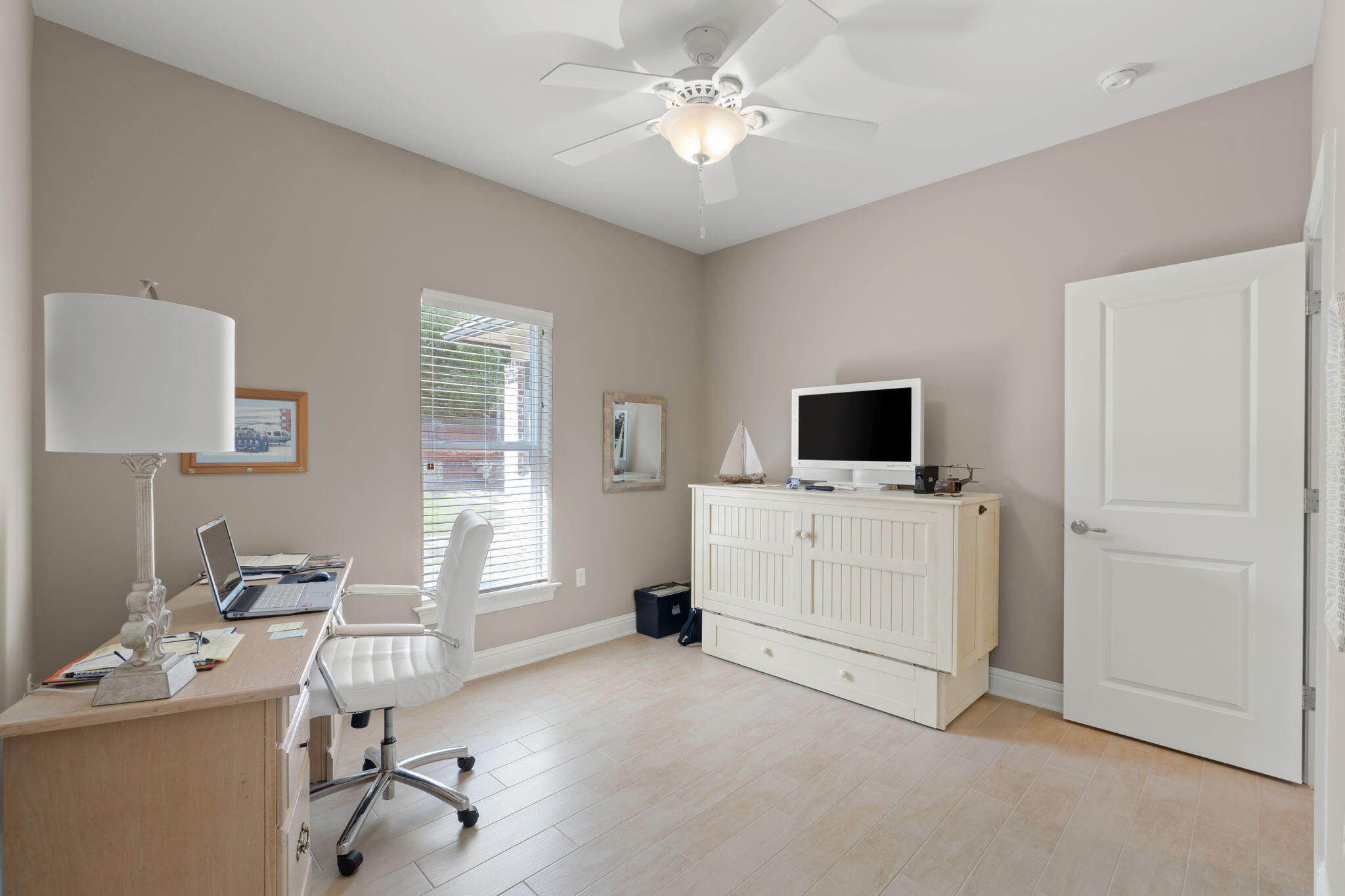 562 Falcon Trail Niceville, FL 32578 - Photo 21 of 40 a view of a workspace with a window and a flat screen tv