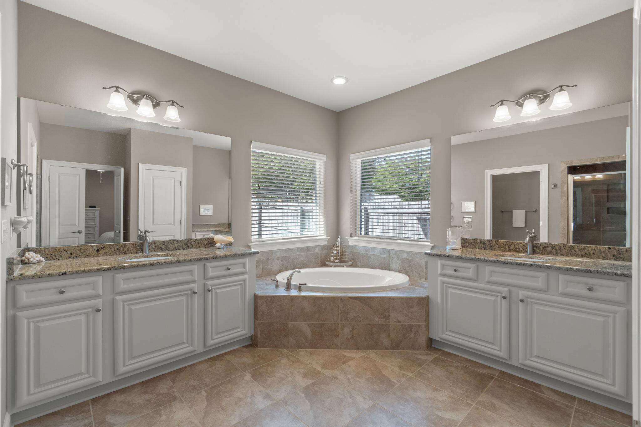 562 Falcon Trail Niceville, FL 32578 - Photo 24 of 40 a spacious bathroom with a granite countertop tub sink and mirror
