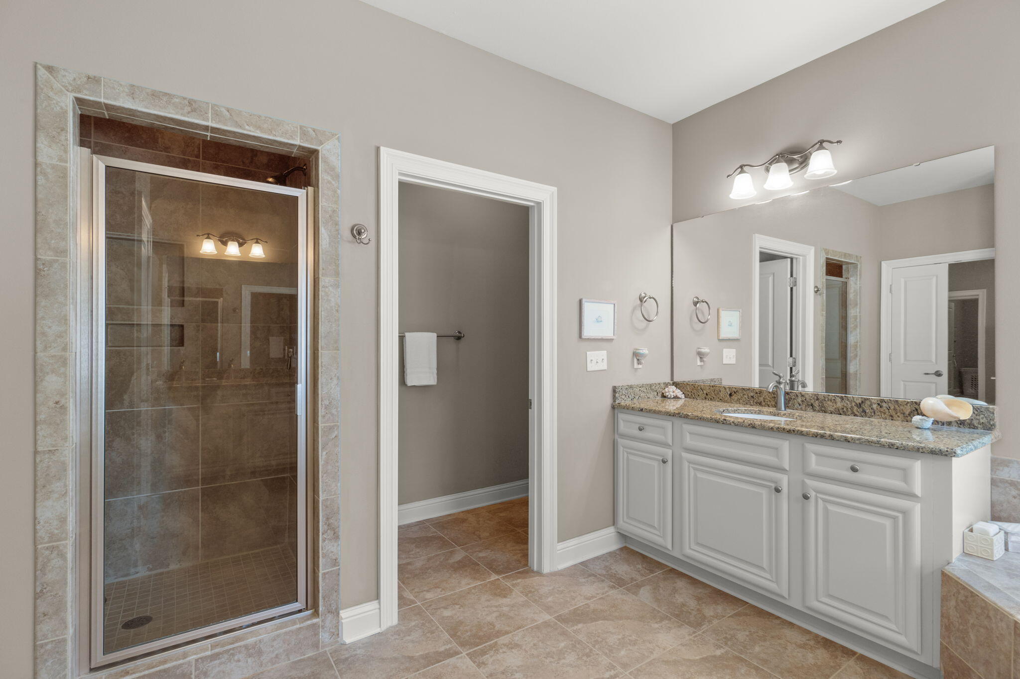 562 Falcon Trail Niceville, FL 32578 - Photo 26 of 40 a bathroom with a granite countertop sink mirror and shower