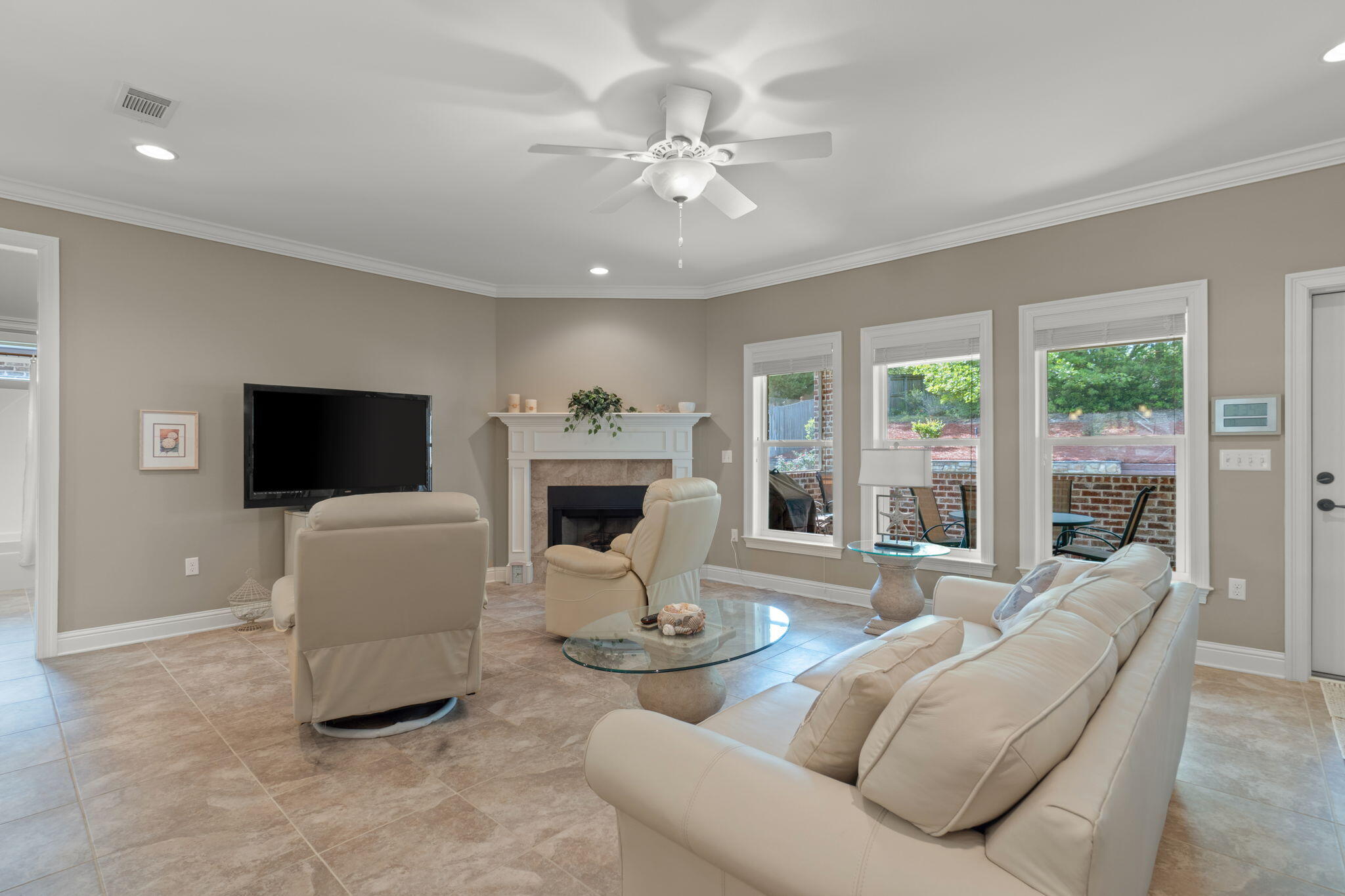 562 Falcon Trail Niceville, FL 32578 - Photo 8 of 40 a living room with furniture a flat screen tv and a large window